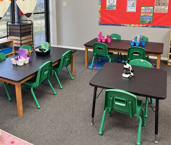 Preschool classroom with small tables and learning materials